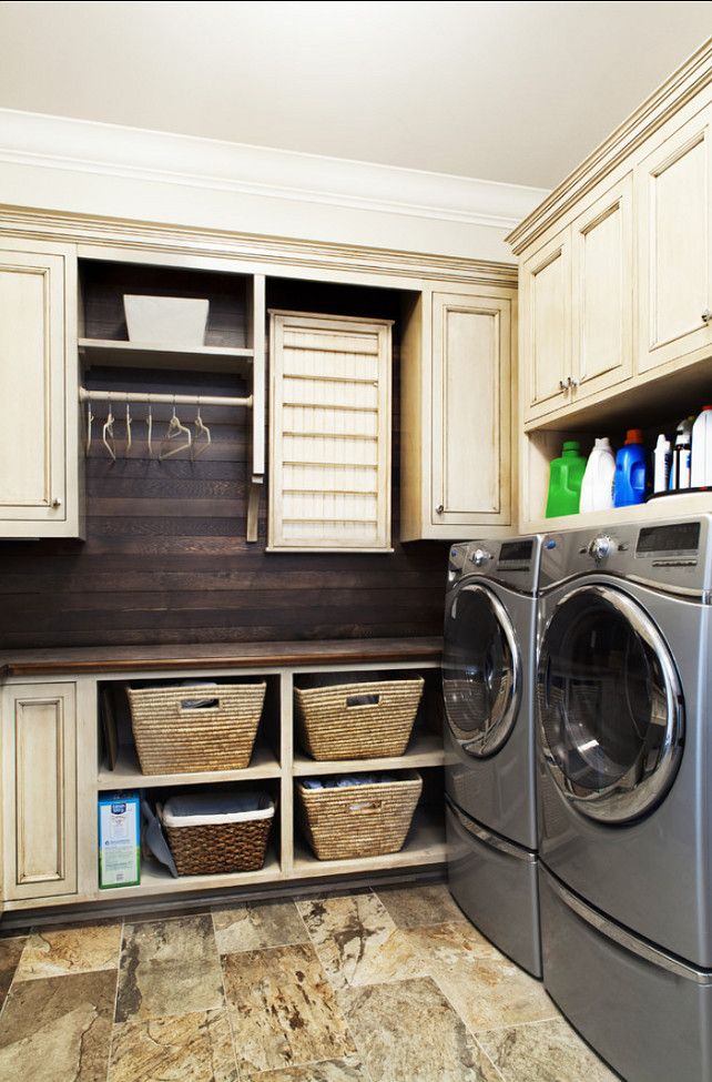 laundry room with dark wood paneling