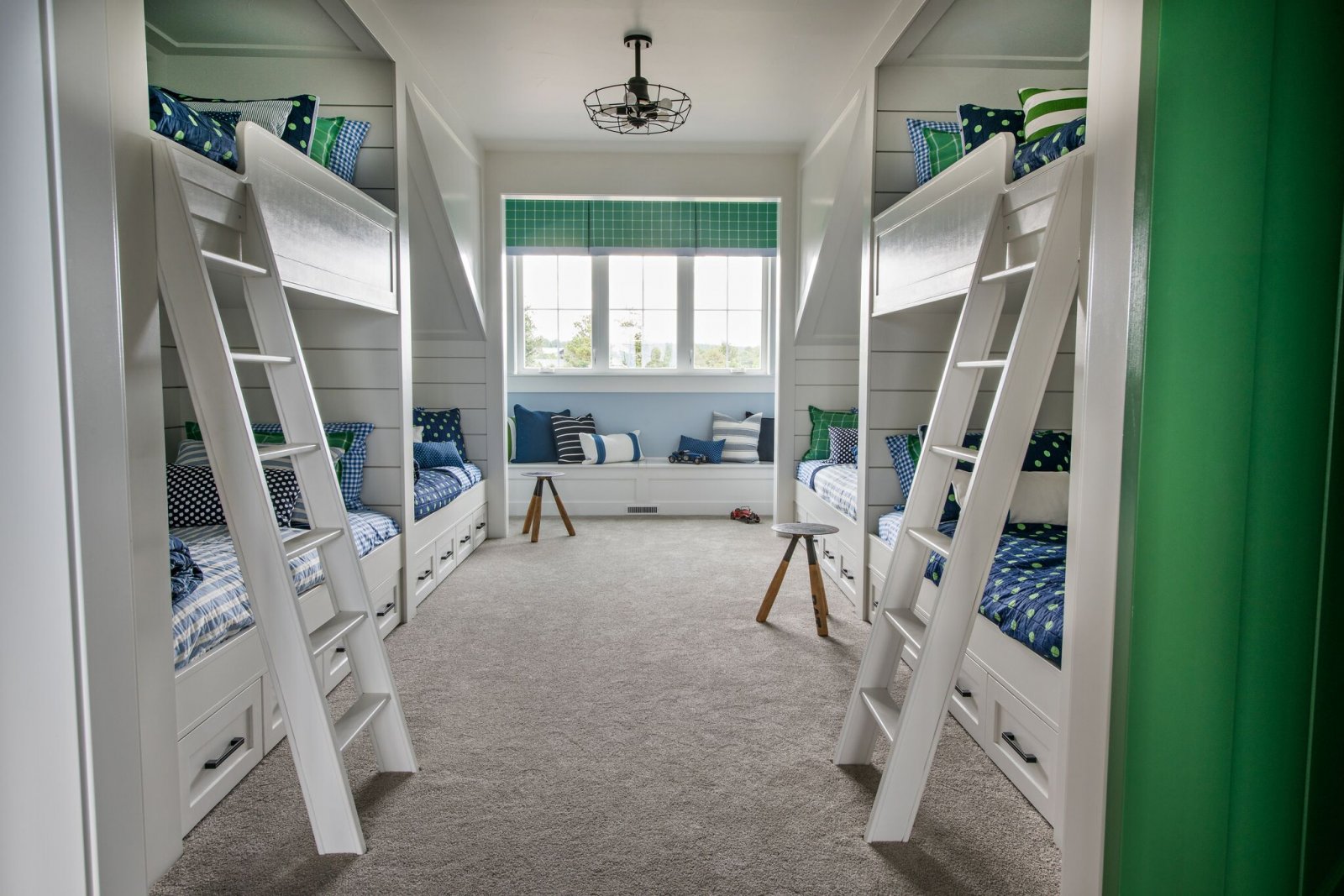 white navy and green bunk room with alcoves
