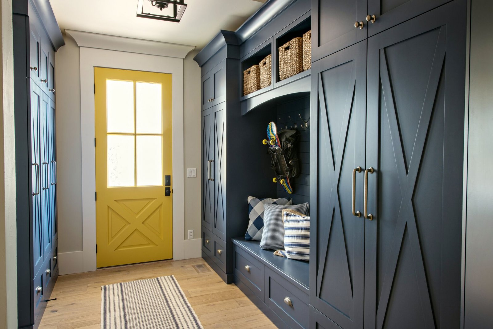 navy and yellow mudroom with bench