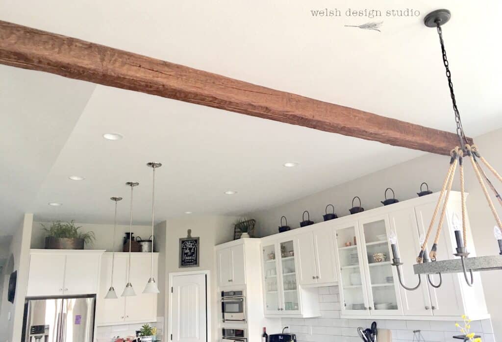 Faux wood beams for ceiling installed between kitchen and dining area